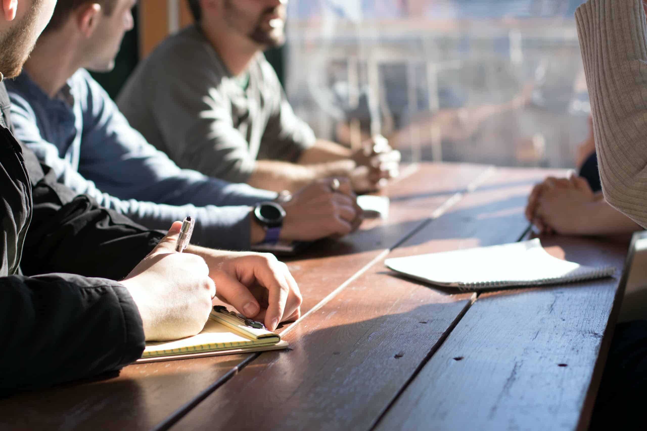 Group of people meeting around table